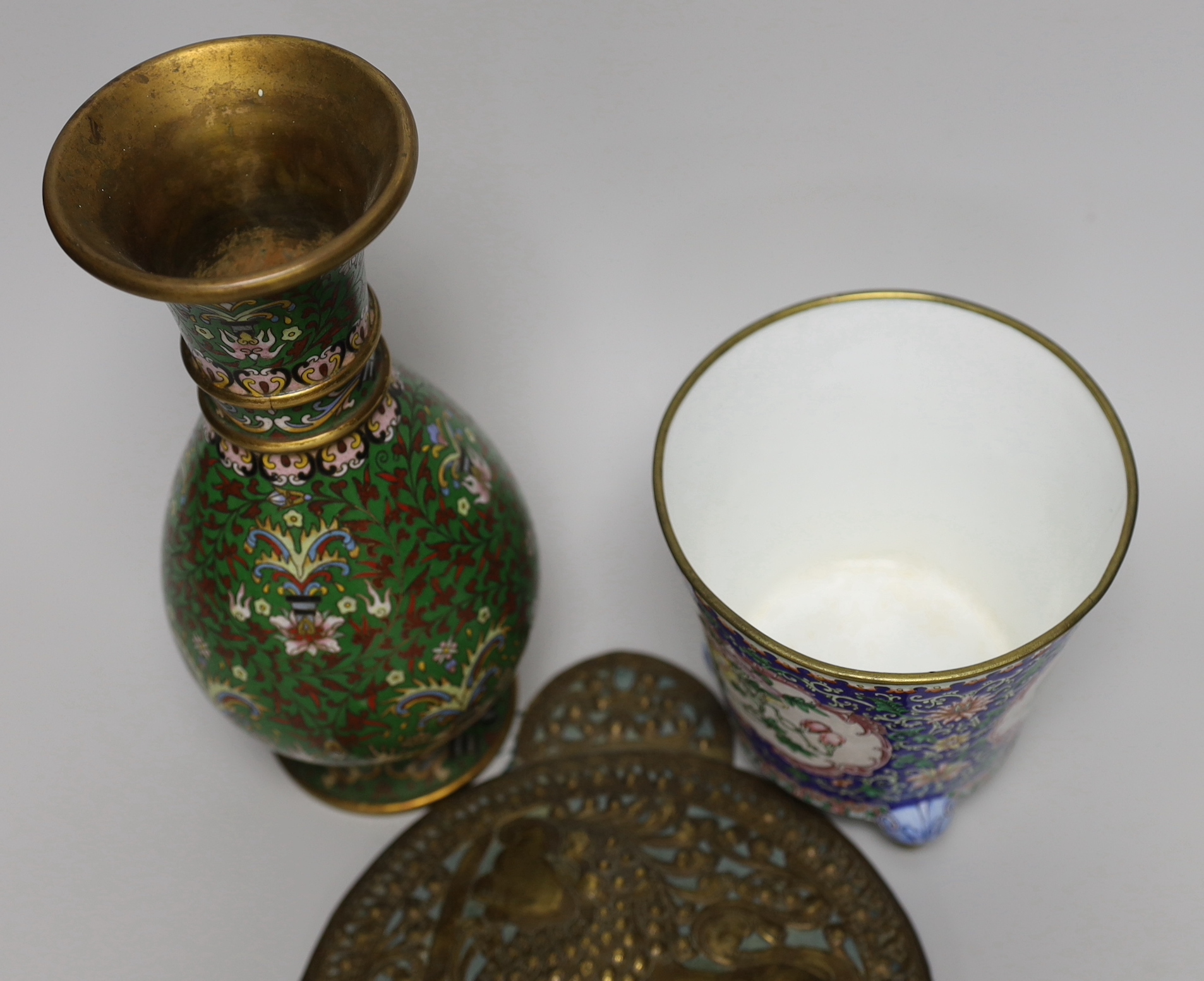 A Chinese Guangzhou enamel vase, a cloisonné enamel vase and an Indonesian brass panel, tallest 26cm high